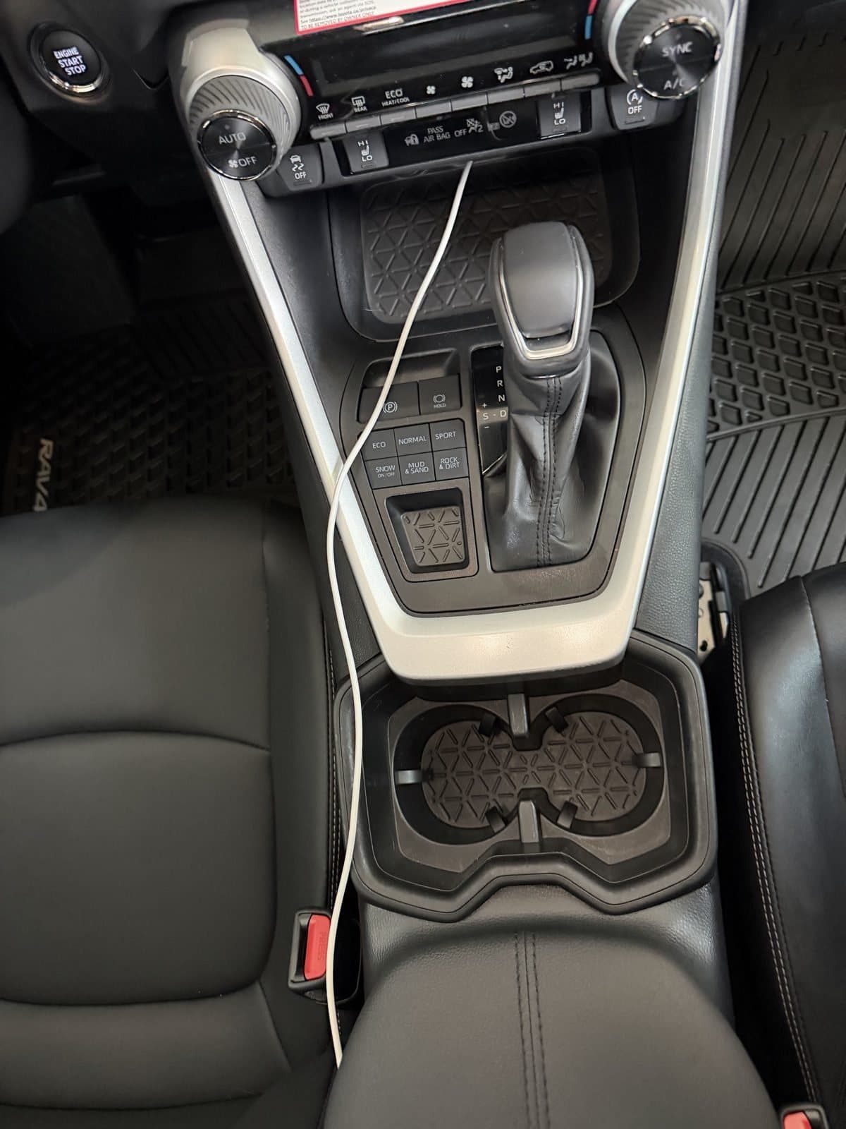 The same RAV4 console after detailing, cup holders and trim clear of debris